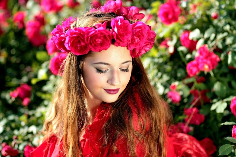 a woman in a red dress with flowers in her hair, by Rhea Carmi, pixabay, rose crown, beautiful young girl, vibrant pink, portal made of roses