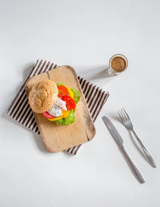 a sandwich sitting on top of a wooden cutting board, a picture, bauhaus, miniature product photo, foodphoto, jakarta, salad and white colors in scheme