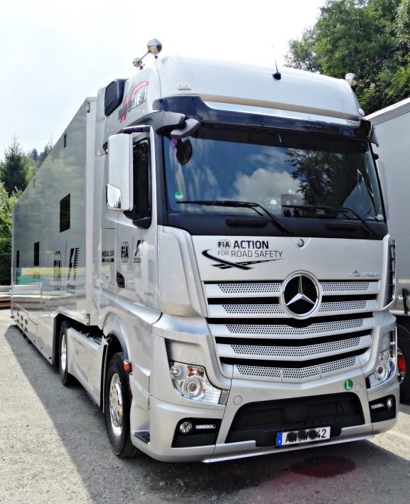 a mercedes semi truck parked in a lot, by Niko Henrichon, figuration libre, at circuit de spa francorchamps, not cropped, photo taken in 2018, photo photo