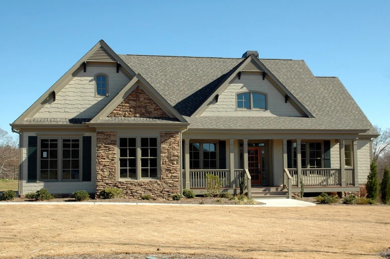 a house with a car parked in front of it, by Joseph Raphael, flickr, front elevation view, granite, roofing tiles texture, craftsman home