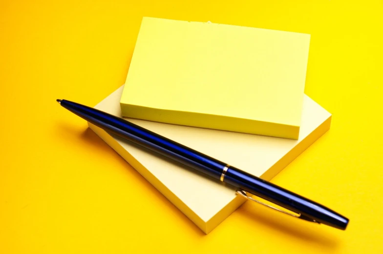 a pen sitting on top of a stack of post it notes, minimalism, yellow walls, highly detailed product photo, portlet photo