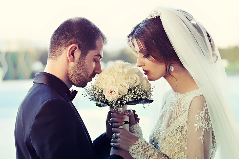 a bride and groom looking at each other, a picture, by Arthur Sarkissian, shutterstock, romanticism, holding flowers, instagram picture, true realistic image, lovingly looking at camera