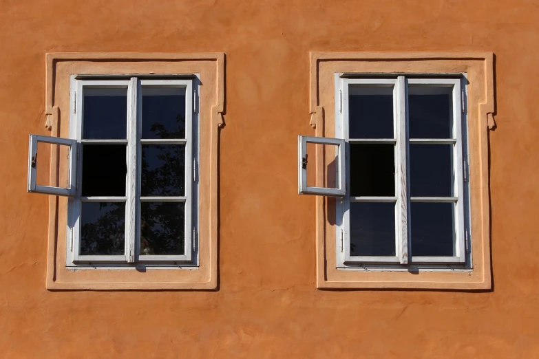 a close up of two windows on a building, inspired by Jan Kupecký, pixabay, precisionism, hammershøi, white and orange, 1 8 th century style, light - brown wall