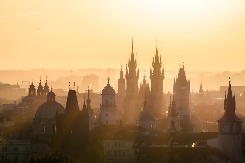 a view of a city from the top of a hill, by Gusztáv Kelety, shutterstock, baroque, majestic spires, back lit, soft morning light, silhouetted