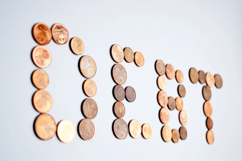 a close up of a number of coins on a wall, a digital rendering, pexels, letterism, copper, deezen, idealised, doe