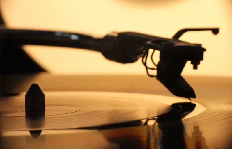 a close up of a record on a turntable, an album cover, by Jay Hambidge, unsplash, google glass, microphone silluette, spectacles, close up shot from the side