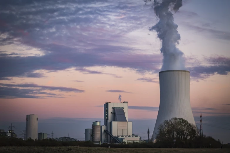 a factory with a lot of smoke coming out of it, a picture, by Thomas Häfner, shutterstock, nuclear art, dusk setting, chimney with smoke, 8 0 mm photo, colour corrected