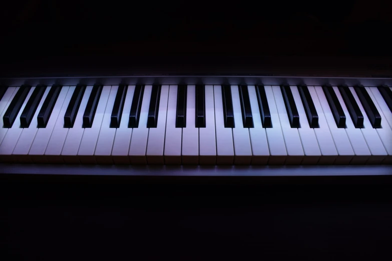 a close up of a piano keyboard in the dark, by Andrei Kolkoutine, shutterstock, caustics lighting from above, isolated background, purple volumetric lighting, shot at night with studio lights