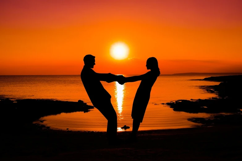 a couple of people standing on top of a beach, pixabay contest winner, romanticism, dancing with each other, ! holding in his hand !, orange sun set, symmetric