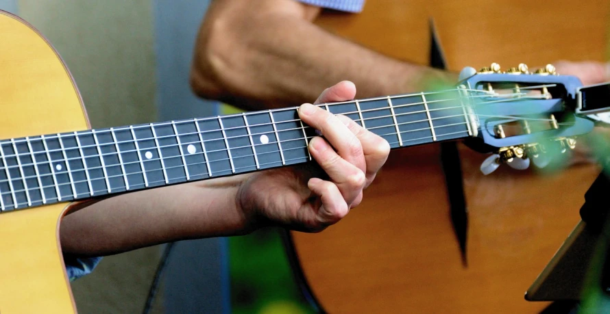 a close up of a person playing a guitar, by Mike Bierek, figuration libre, enhanced hands, file photo, accurate details, hands retouched