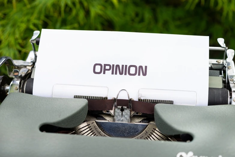 a close up of a typewriter with a paper on it, a stock photo, by Niko Henrichon, institutional critique, optimism, on a green lawn, view from a news truck, covid