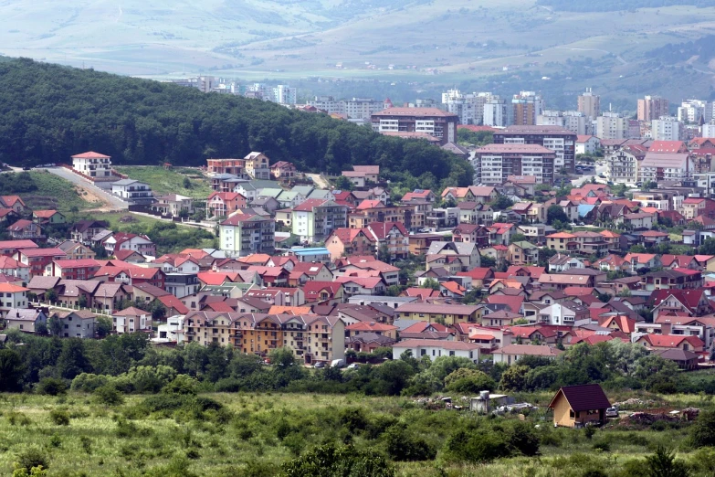 a view of a city from the top of a hill, inspired by Slobodan Pejić, modern high sharpness photo, log houses built on hills, 2000s photo, zoomed out shot