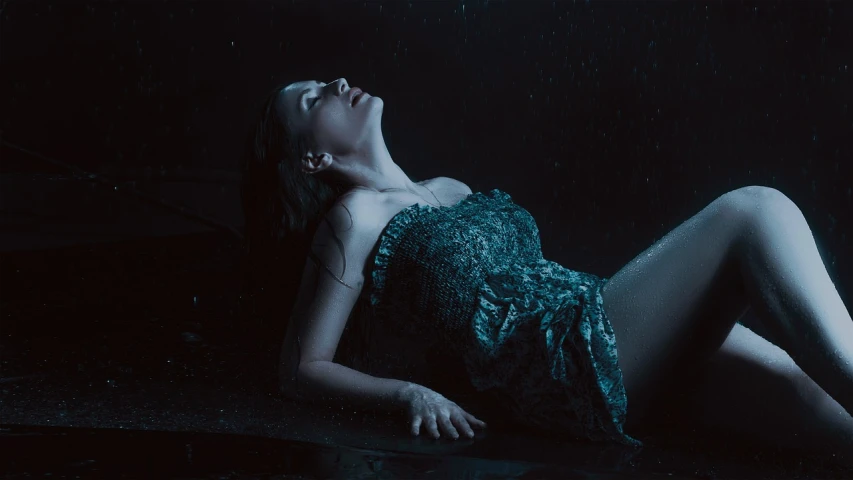 a woman laying on the ground in the rain, a portrait, cgsociety contest winner, art photography, style of suspiria and neon demon, wearing a dress made of water, 7 0 mm. dramatic lighting, gif