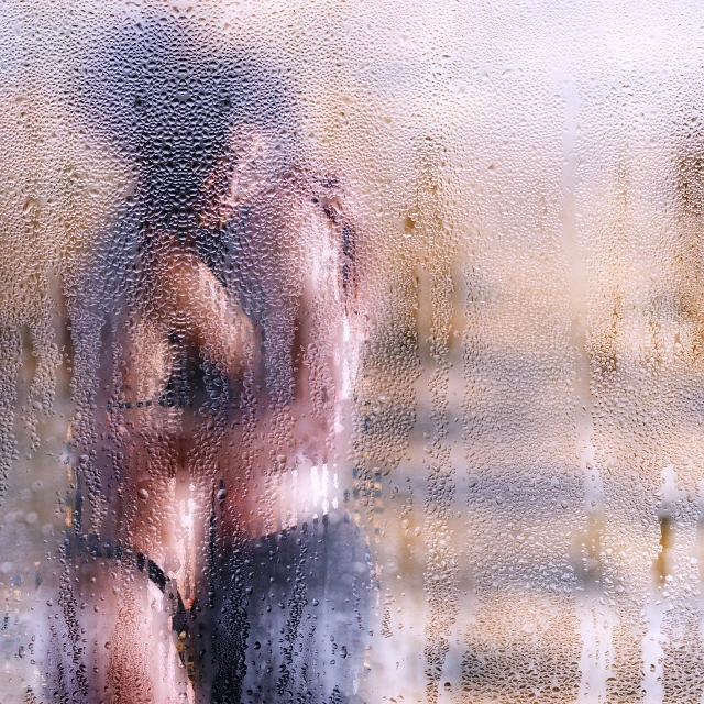 a man standing in front of a window covered in rain, a picture, by Jan Rustem, romanticism, lesbian embrace, defocus, hot summer day, bathing in light