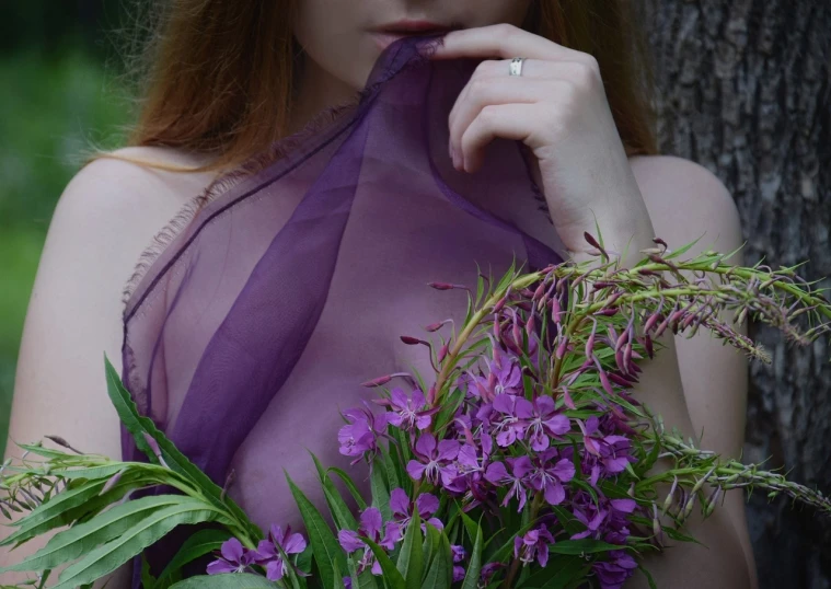 a woman in a purple dress holding a bouquet of flowers, a portrait, by Zofia Stryjenska, pexels, romanticism, diaphanous translucent cloth, lustful vegetation, overgrown with thick orchids, soft translucent fabric folds
