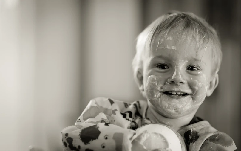 a young boy with food all over his face, a black and white photo, by Lee Loughridge, unsplash, cake, closeup of an adorable, a plaster on her cheek, highly detailed photo of happy