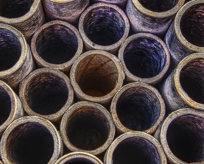 a bunch of metal pipes stacked on top of each other, a picture, by Stefan Lochner, shutterstock, folk art, close macro photo. studio photo, cardboard tunnels, sanjulian. detailed texture, layers of strata