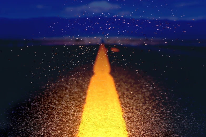 a yellow line in the middle of a road, a microscopic photo, conceptual art, fireflies and sparkling wisps, star rain, high res photo, distant mountains lights photo