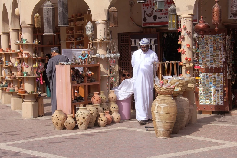 a man that is standing in front of a store, shutterstock, dau-al-set, pottery, dubai, street vendors, usa-sep 20