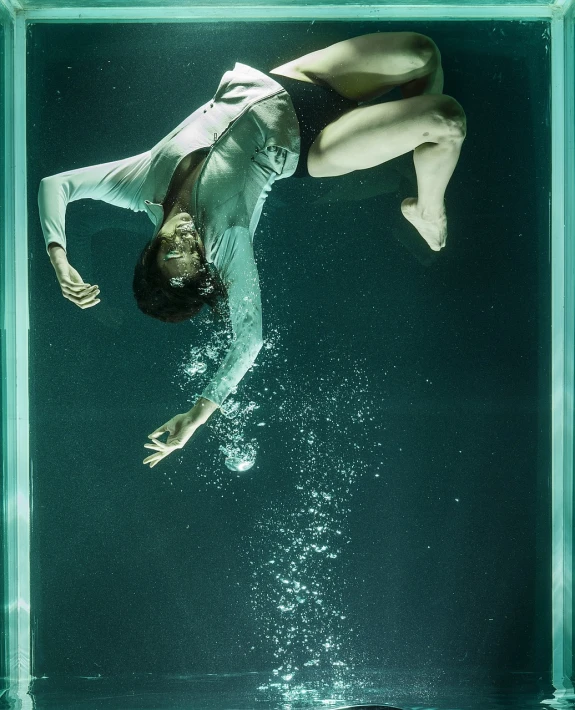 a man dives into a pool of water, a portrait, by Caro Niederer, conceptual art, a woman floats in midair, glass floor, production still, promotional image