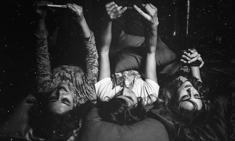 a group of people laying on top of each other, a black and white photo, tumblr, conceptual art, stoner rock, inherent vice, phone wallpaper, liquid gold