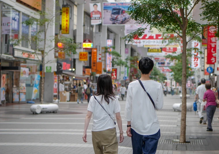 a man and a woman walking down a city street, by Kamagurka, shutterstock, japan poster, distant full body view, wearing white clothes, high quality picture