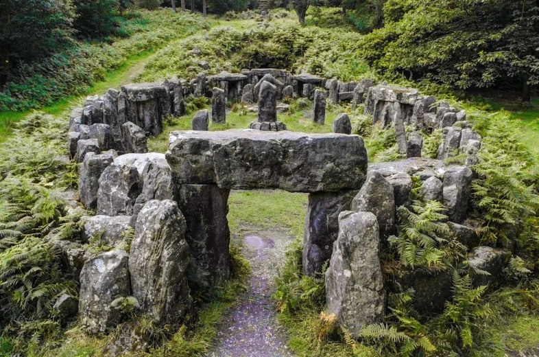 a stone circle in the middle of a forest, in an ancient altar, there is a place in wales, symmetrical long head, inside her temple