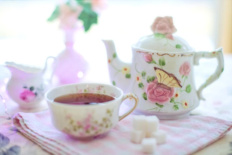 a tea pot sitting on top of a table next to a cup of tea, a picture, by Rhea Carmi, shutterstock, romanticism, with soft pink colors, 🐝👗👾, pink white and green, square