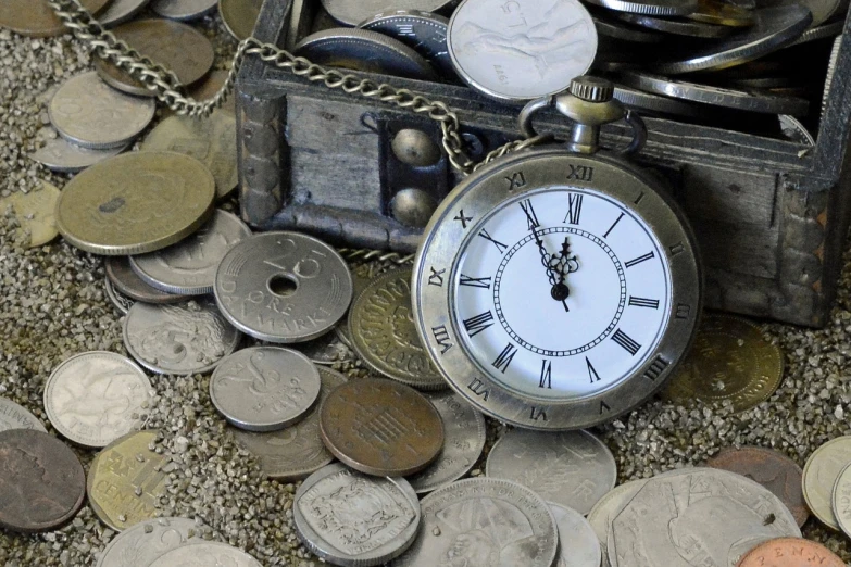 a pocket watch sitting on top of a pile of coins, assemblage, treasure chests, ebay photo