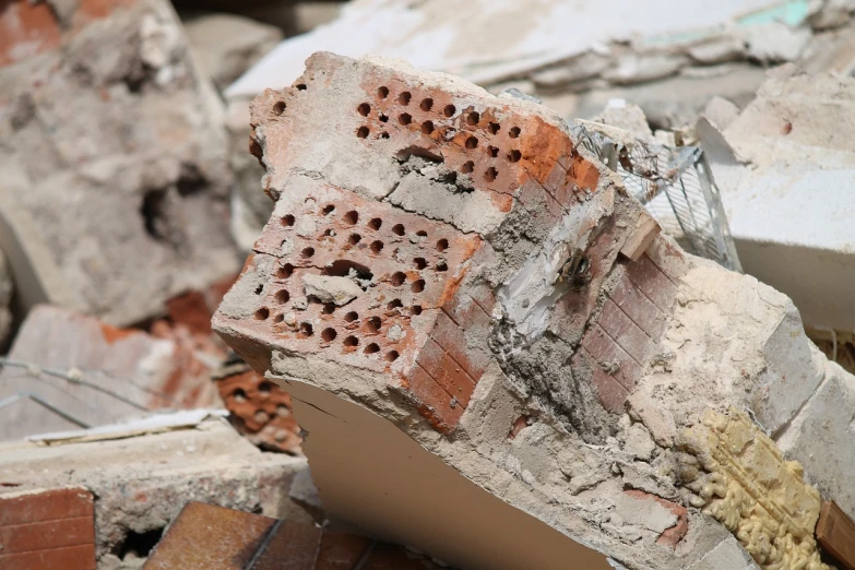 a pile of bricks sitting on top of a pile of rubble, a photo, closeup photo, many holes, 2 0 2 2 photo, restoration