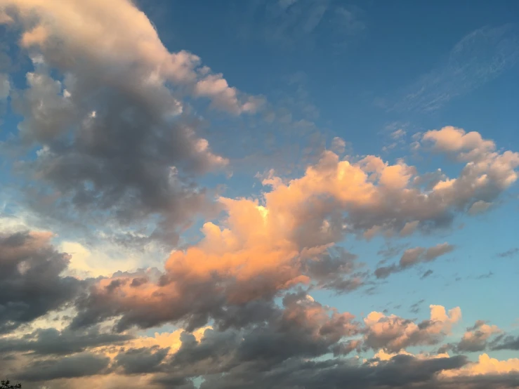 a plane flying through a cloudy blue sky, by Linda Sutton, romanticism, beautiful new mexico sunset, soft blue and pink tints, cloud and sky color scheme, late summer evening