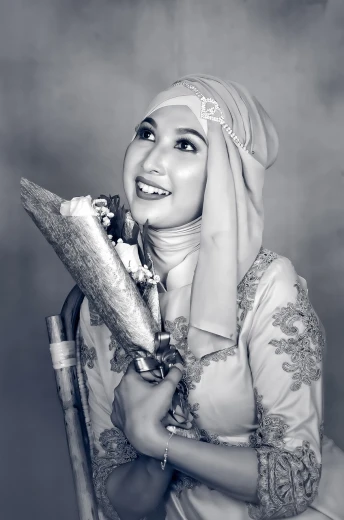 a black and white photo of a woman in a hijab, a black and white photo, inspired by Nazmi Ziya Güran, tumblr, holding scimitar made of bone, bouquet, radiant smile. ultra wide shot, enhanced photo