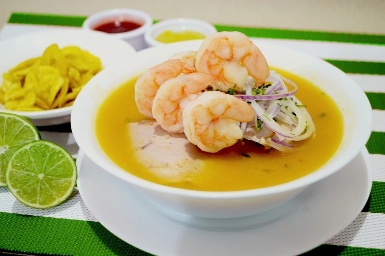 a bowl of soup sitting on top of a white plate, rasquache, golondrinas, prawn, colombian, loli