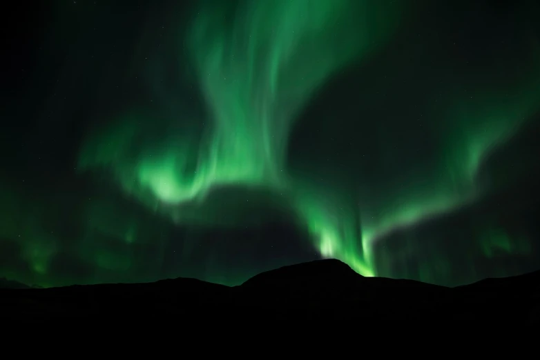 the aurora bore lights up the night sky, by Ejnar Nielsen, pexels contest winner, hurufiyya, beautiful lighting uhd, mountain, whirling, istock