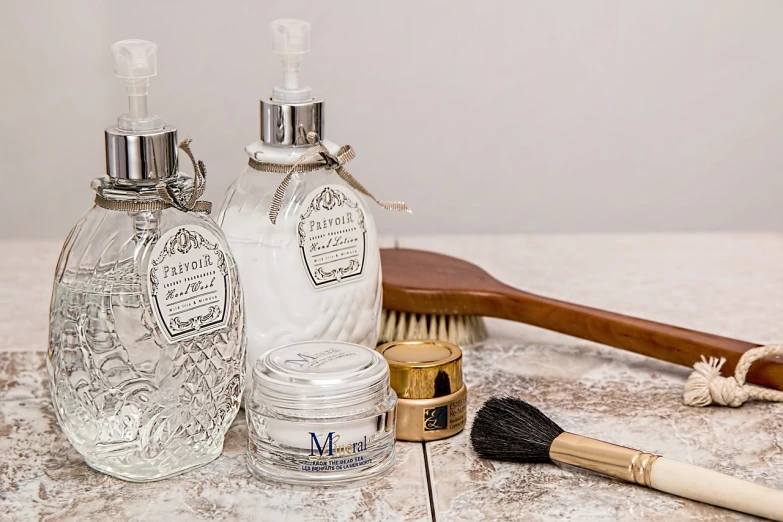 a number of items on a table with a brush, pixabay, renaissance, skincare, bottle, engraved, transparent