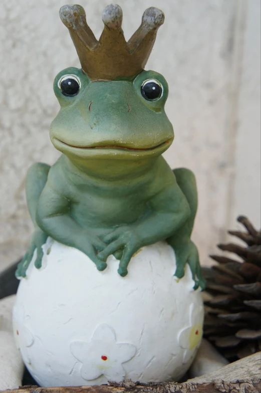 a frog with a crown sitting on top of an egg, a portrait, flickr, resin statue, a photo of a frog with a hat, handsome, mmmmm