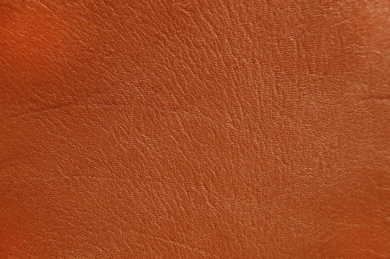 a close up of a brown leather surface, a stock photo, realistic textures from photos, red and orange colored, very sharp photo, high detail product photo