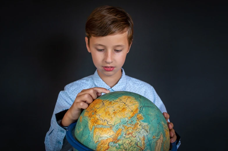 a young boy holding a globe in his hands, a picture, well-groomed model, photo taken in 2 0 2 0, product introduction photo, focused on neck