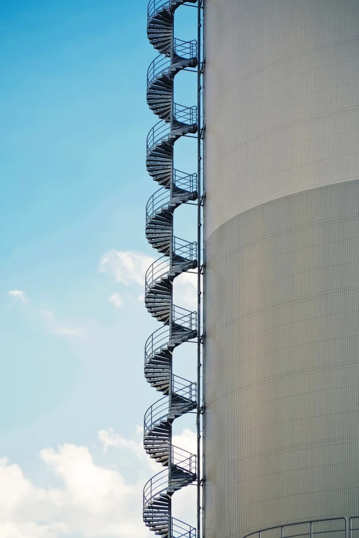 a tall metal spiral staircase next to a building, by Jan Rustem, minimalism, chemical plant, stairway to heaven, hoog detail, beautiful views