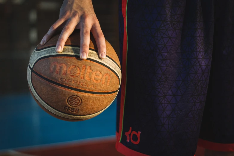 a close up of a person holding a basketball, a picture, trending on dribble, realism, mateo dineen, sport clothing, marketing photo, 💣 💥💣 💥