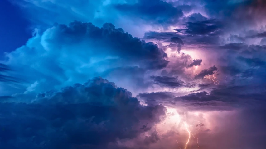 a large cloud filled with lots of lightning, pexels, romanticism, blue and violet, cinematic stormy sky, glistening clouds in background, strong blue and orange colors