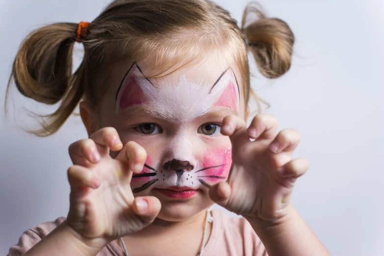 a little girl with her face painted like a cat, inspired by Federico Barocci, shutterstock, square, “pig, stock photo, scratches on photo