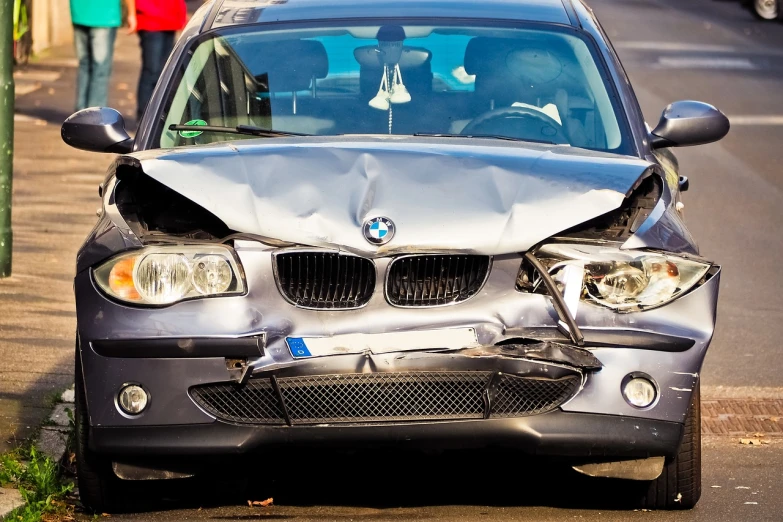 a car that is sitting on the side of the road, auto-destructive art, bmw, front of car angle, accidents, up close picture