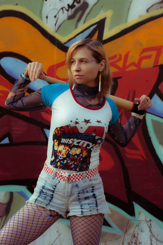 a woman holding a baseball bat in front of a graffiti wall, a portrait, inspired by Edo Murtić, tumblr, mesh shirt, harley quinn film still, chucky style, olya bossak