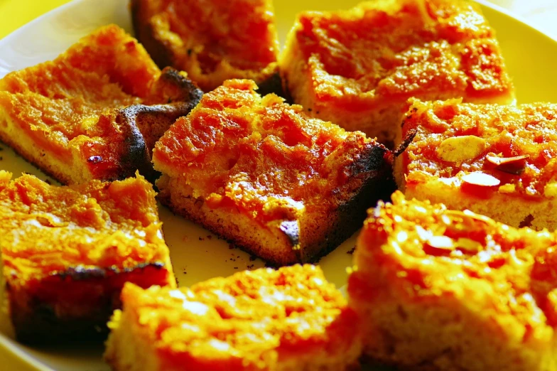 a close up of a plate of food on a table, a photo, inspired by Géza Dósa, flickr, hurufiyya, slices of orange, brood spreading, squares, !!highly detalied