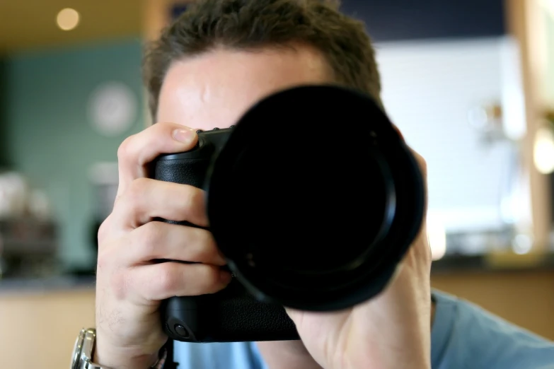 a man taking a picture with a camera, by Juan O'Gorman, close up dslr studio photograph, 4 0 0 mm f 1. 2, spying discretly, blog-photo