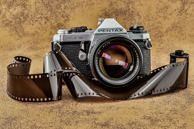 a camera sitting on top of a roll of film, a picture, inspired by roger deakins, pixabay contest winner, photorealism, on pentax 67, color film photography 1970s, old sepia photography, photorealism. trending on flickr