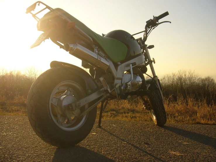 a motorcycle parked on the side of the road, inspired by Alex Petruk APe, spring evening, crazy angle, micro - hurricane, turbo