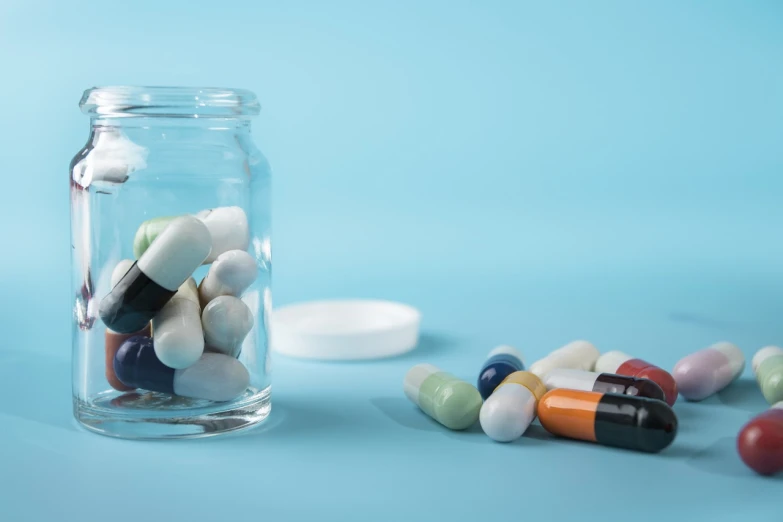 a glass jar filled with assorted pills, a picture, inspired by Damien Hirst, shutterstock, hyperrealism, packshot, ultra wide shot, glass jar, ultra wide-shot