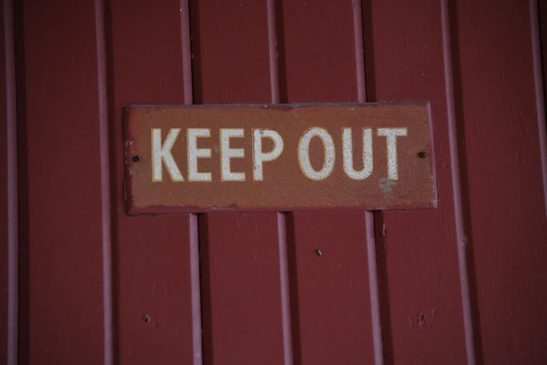 a keep out sign on the side of a building, by Kathleen Guthrie, flickr, shack close up, barn, 1 9 7 0 s photo, trevor carlton